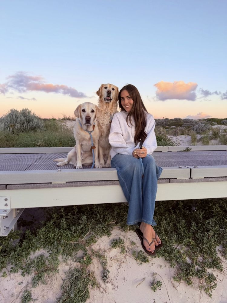 Brooke on a boardwalk with Soy and Sushi at sunset