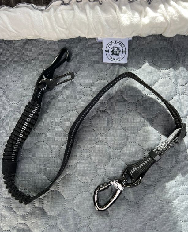 Heavy Duty Dog Seat Belt laid out on the grey seat cover